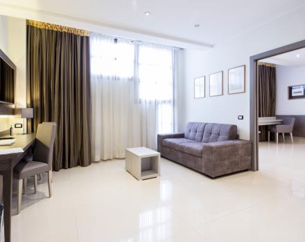 Entrance of the suite room with couch and a desk