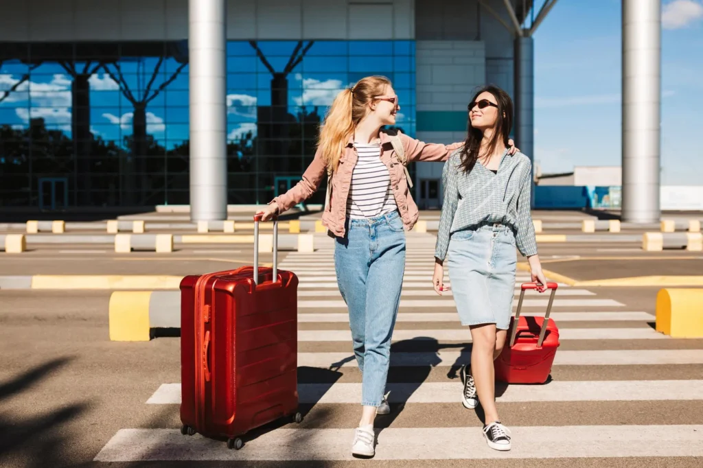 In the image two girls at the airport.