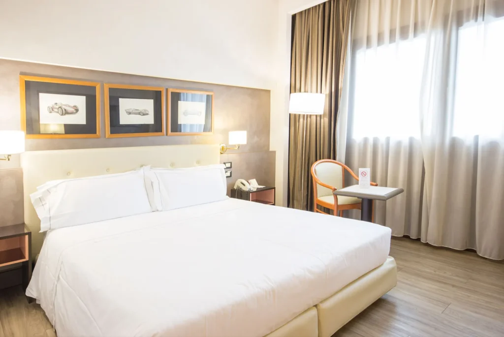 Pictured is a windowed room with a double bed.