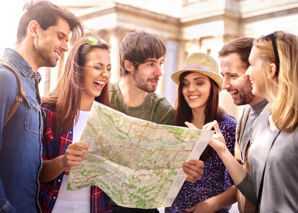 Pictured is a group of kids holding a map visiting the city.